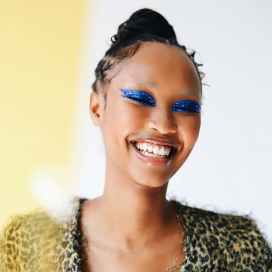 Smiling woman with blue sparkle eye shadow