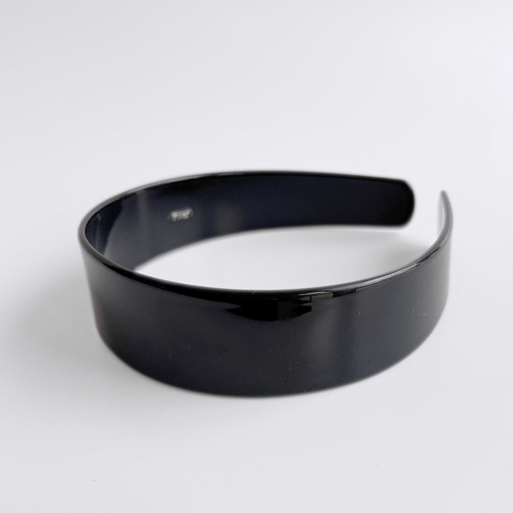 Black headband on a white background