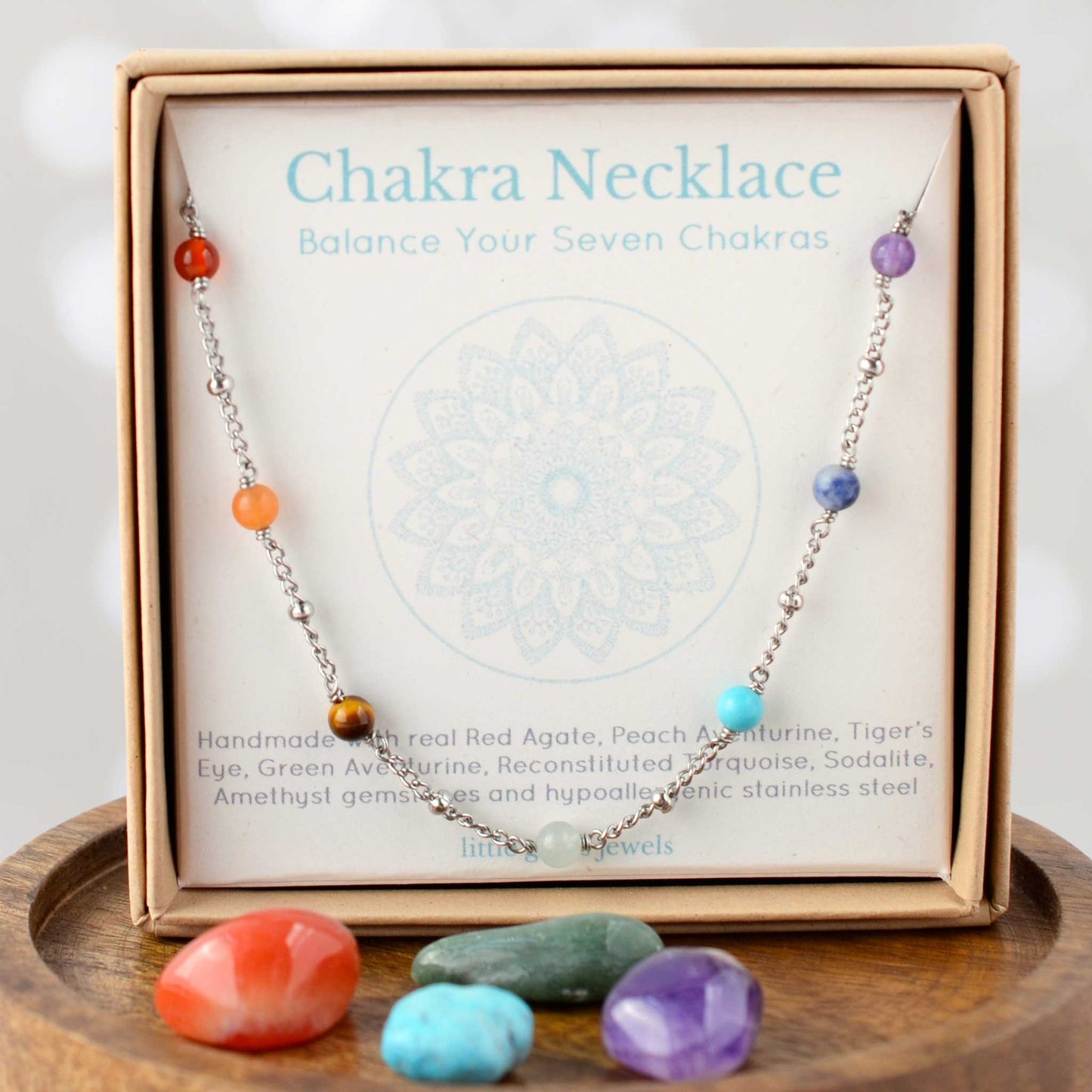 Chakra necklace in eco-friendly gift box on mandala design gift card.