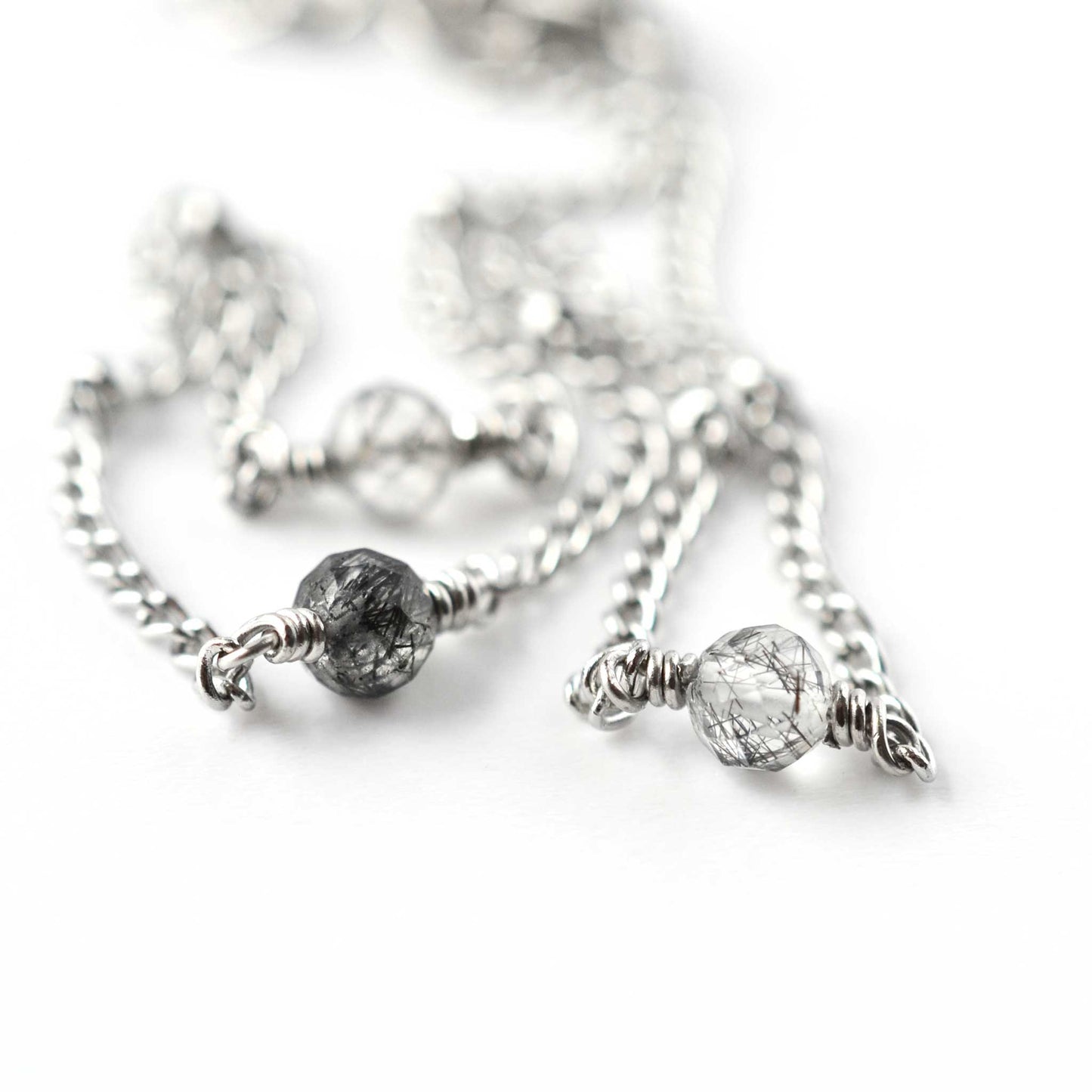 Close up of 4mm Tourmalinated Quartz beads on stainless steel anklet