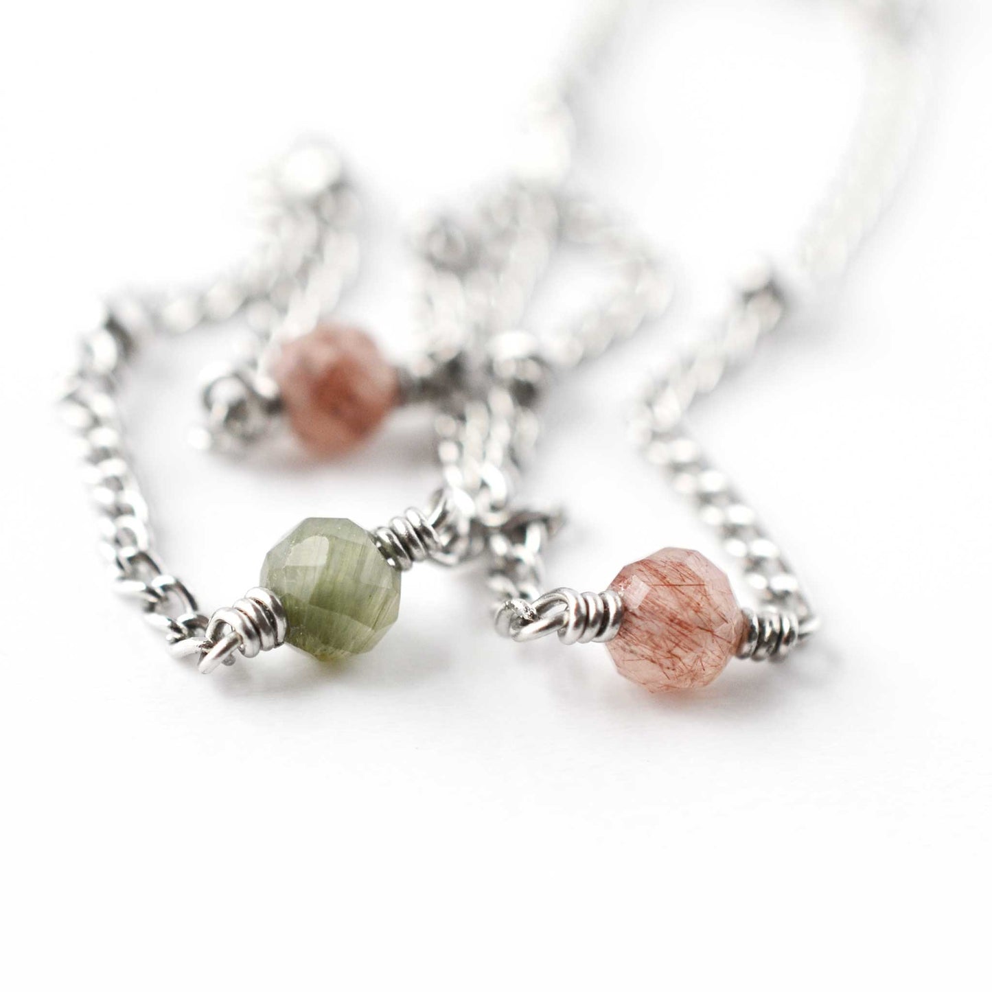 Close up of 4mm green and pink Quartz beads on stainless steel anklet