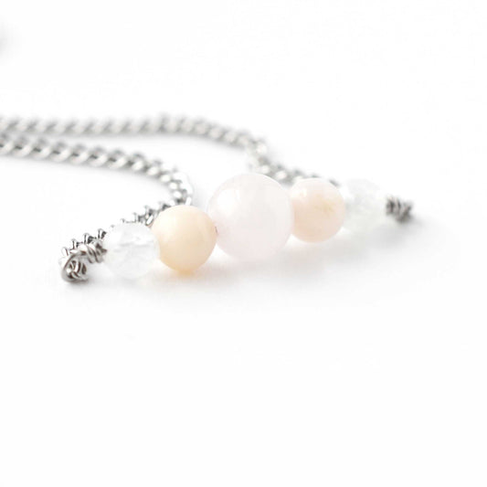 Close up of Rose Quartz, Pink Opal & Rainbow Moonstone gemstone beads on stainless steel necklace