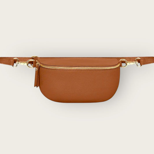 Brown belt bag with gold zipper on a light beige background