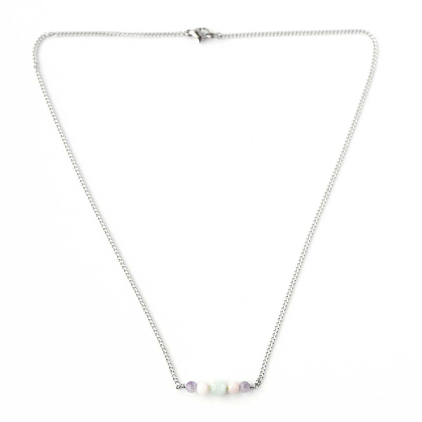Flatlay of dainty pastel gemstone necklace with stainless steel chain and lobster clasp