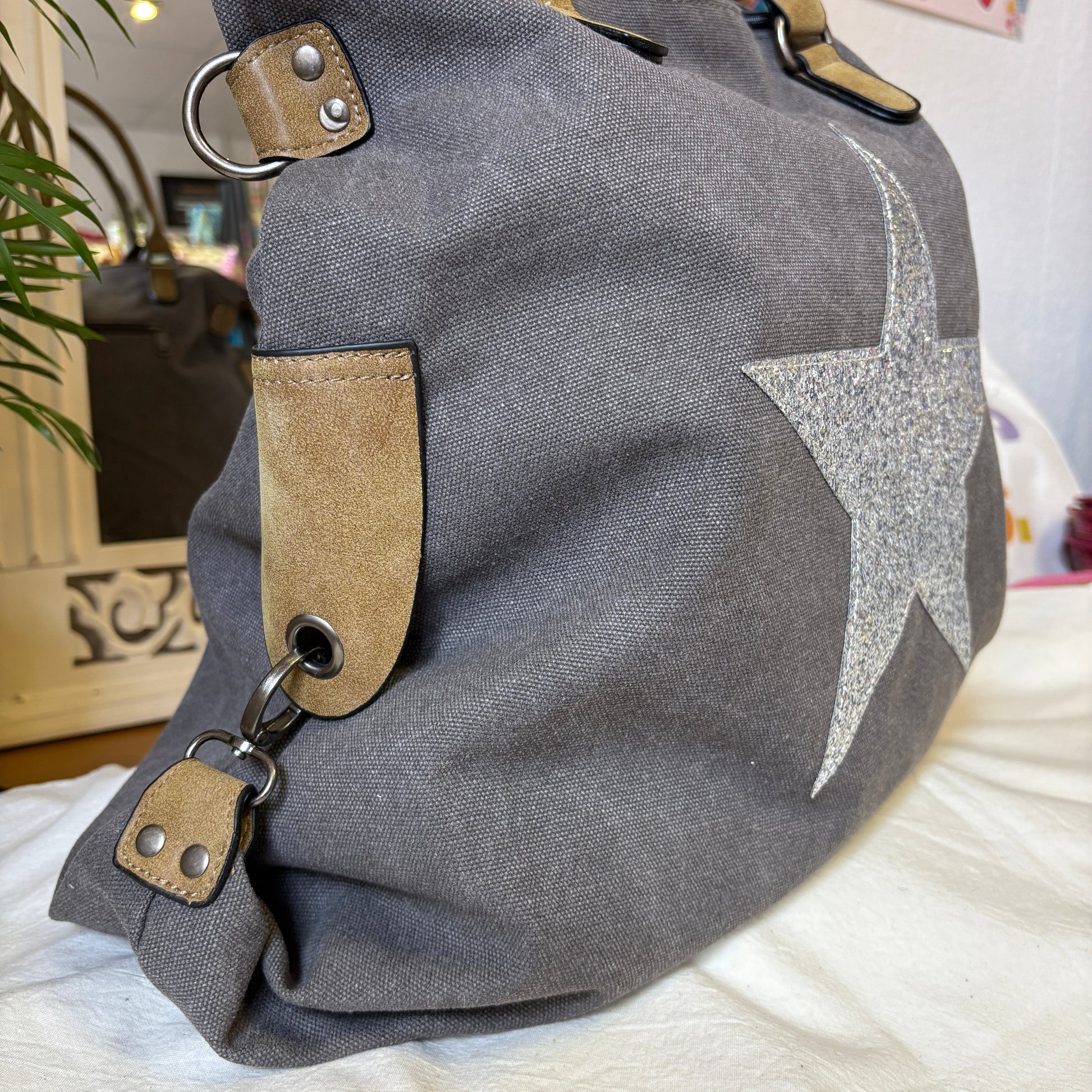 Gray bag with a star design on a white surface