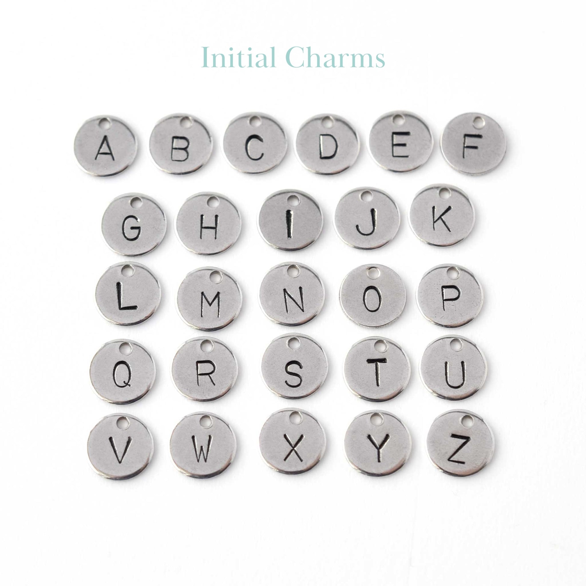 Hand stamped disc charms with initials.