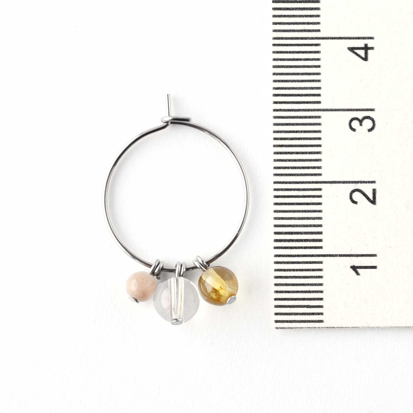 2cm diameter hoop earring with yellow gemstone beads next to ruler