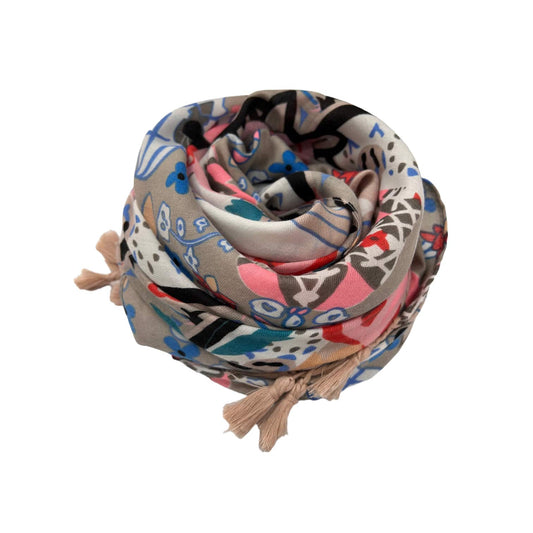 Colorful patterned scarf with tassels on a white background