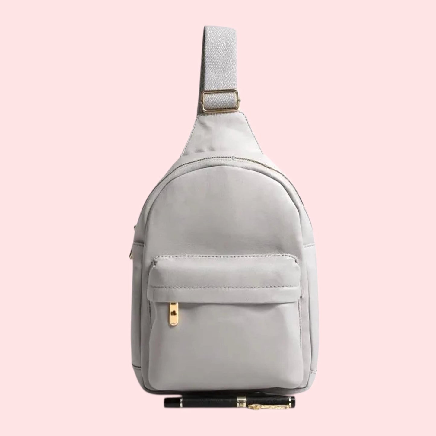 Light gray sling bag on a pink background