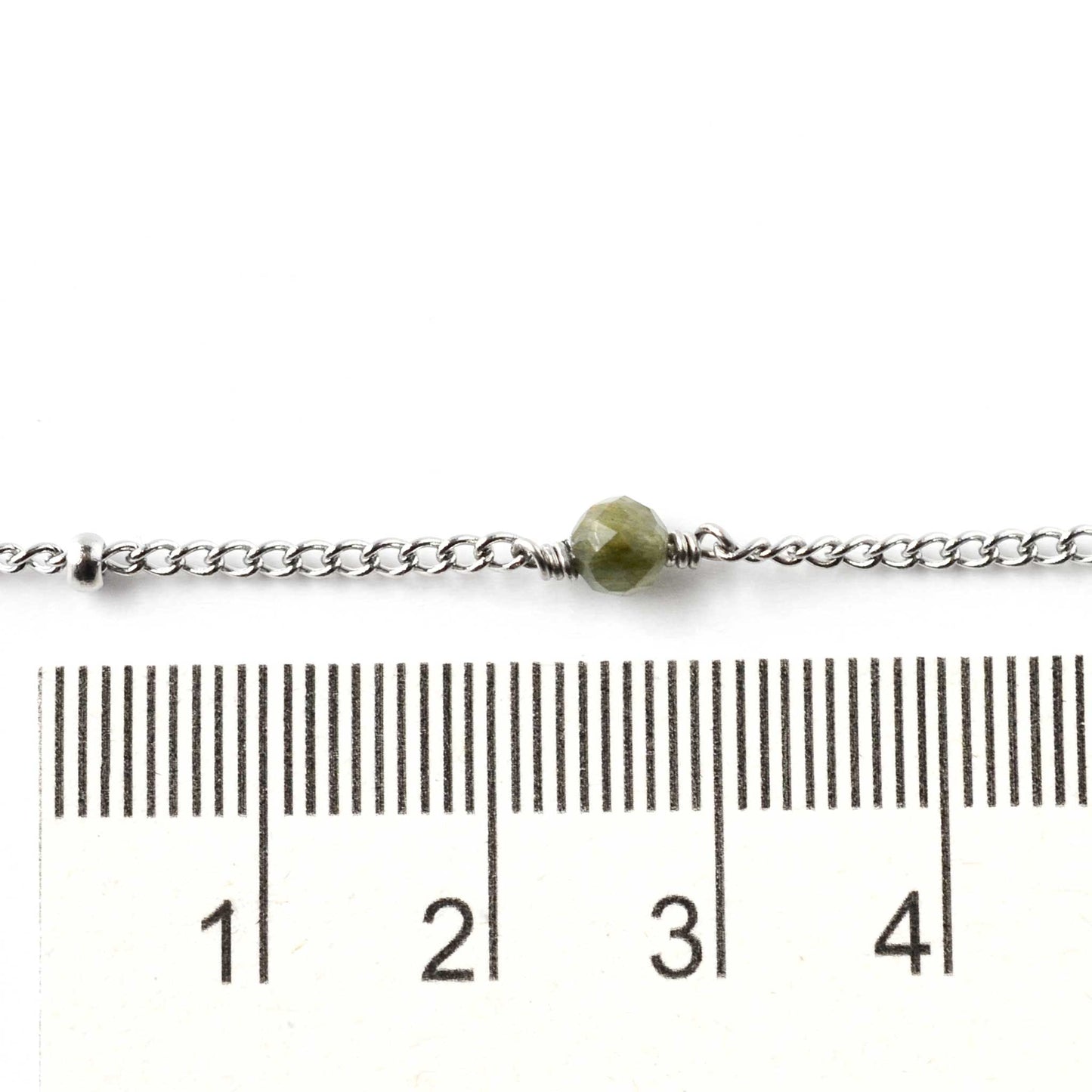 4mm gemstone bead on stainless steel ankle bracelet next to ruler