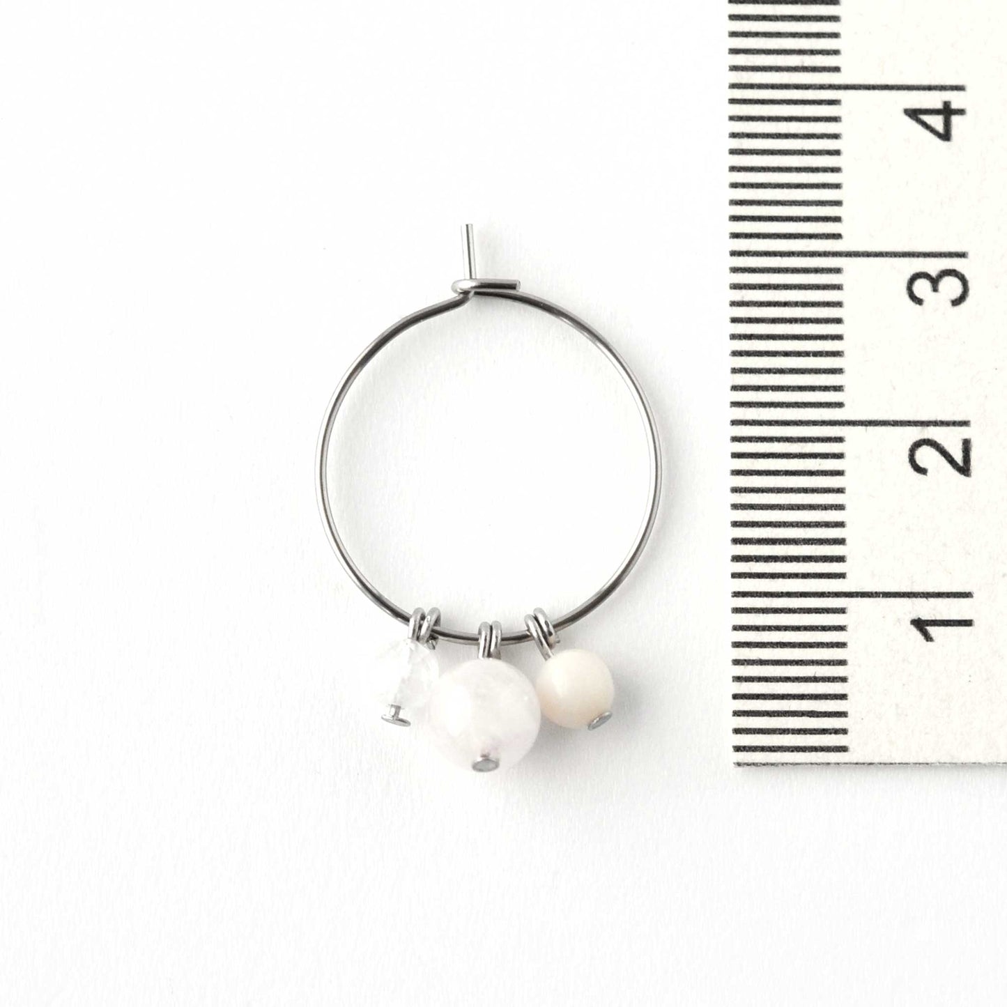 2cm diameter hoop earring with pale pink gemstone beads next to ruler