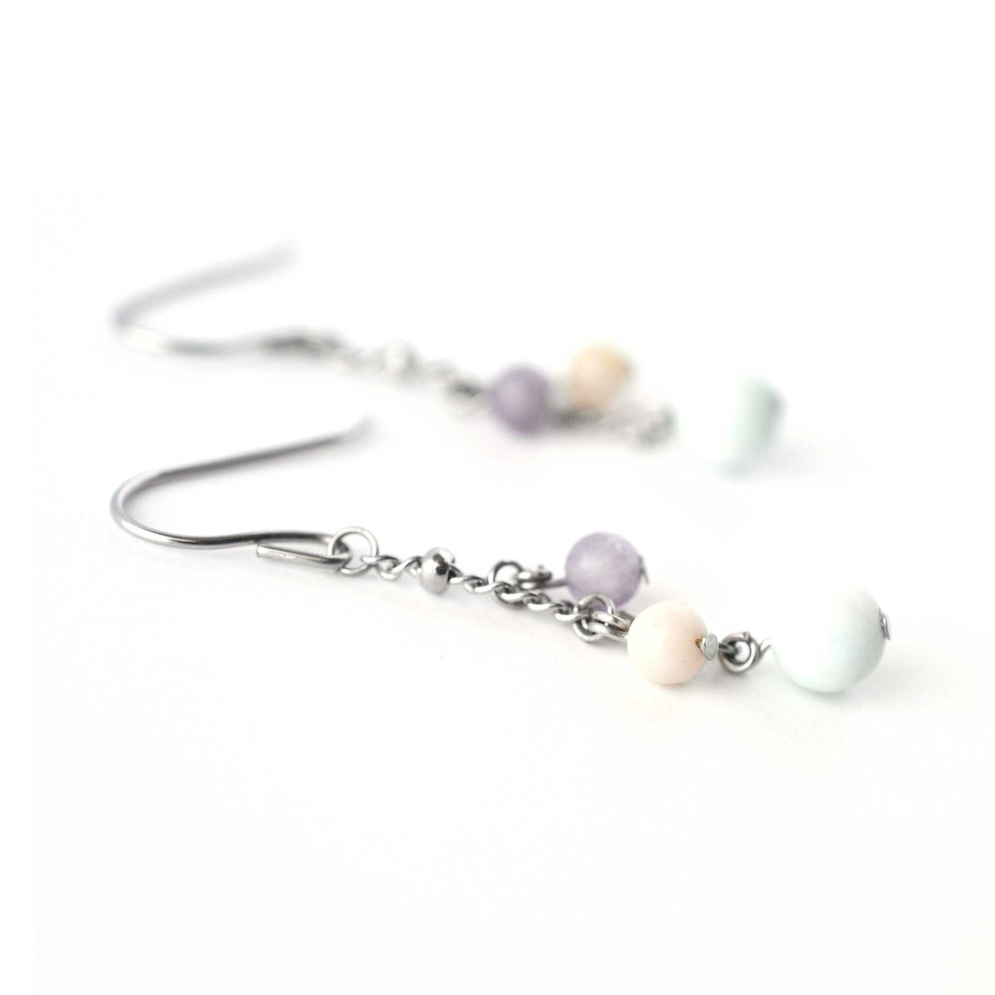 Close up view of gemstone drop earrings with Larimar, Pink Opal & Lepidolite beads