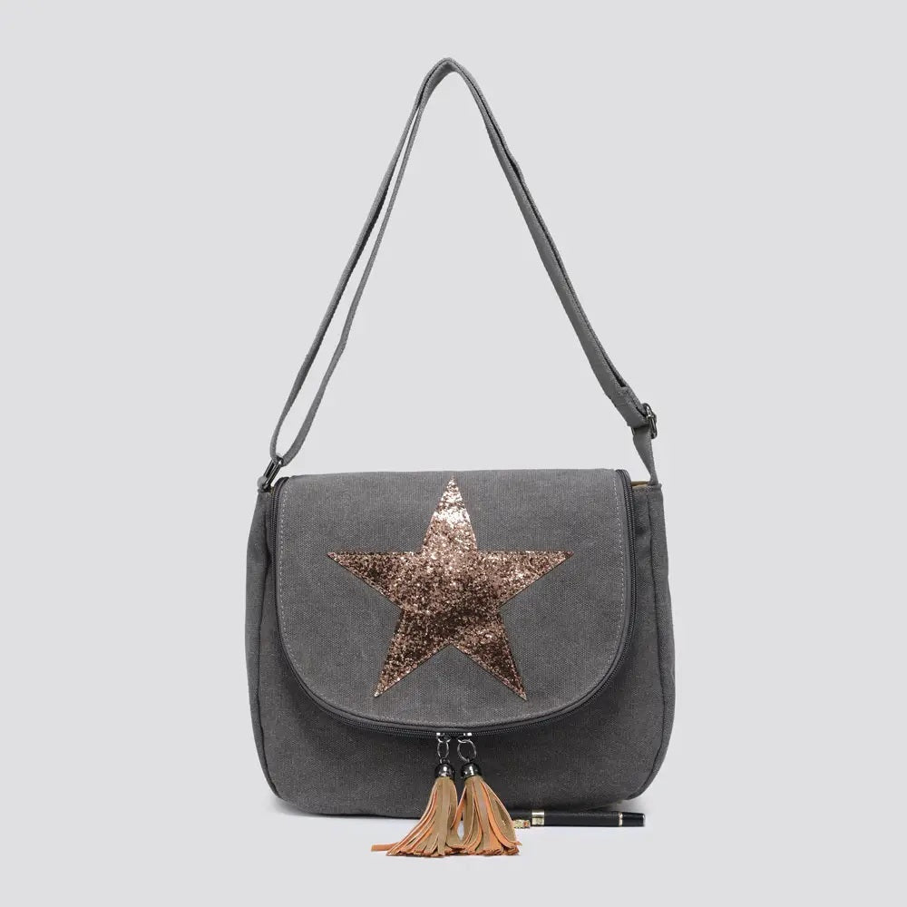 Gray handbag with a star design and tassels on a light gray background