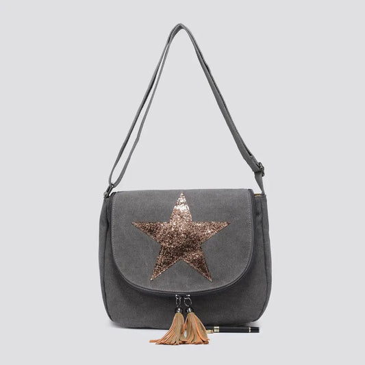 Gray handbag with a star design and tassels on a light gray background