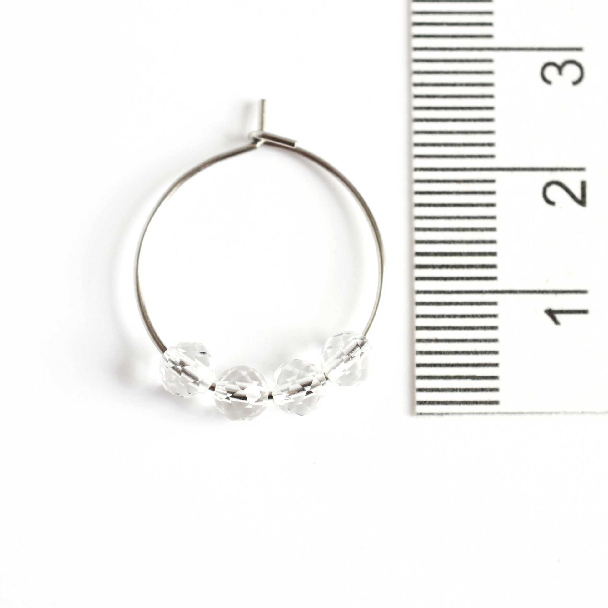 2cm diameter Rock Crystal hoop earrings next to ruler