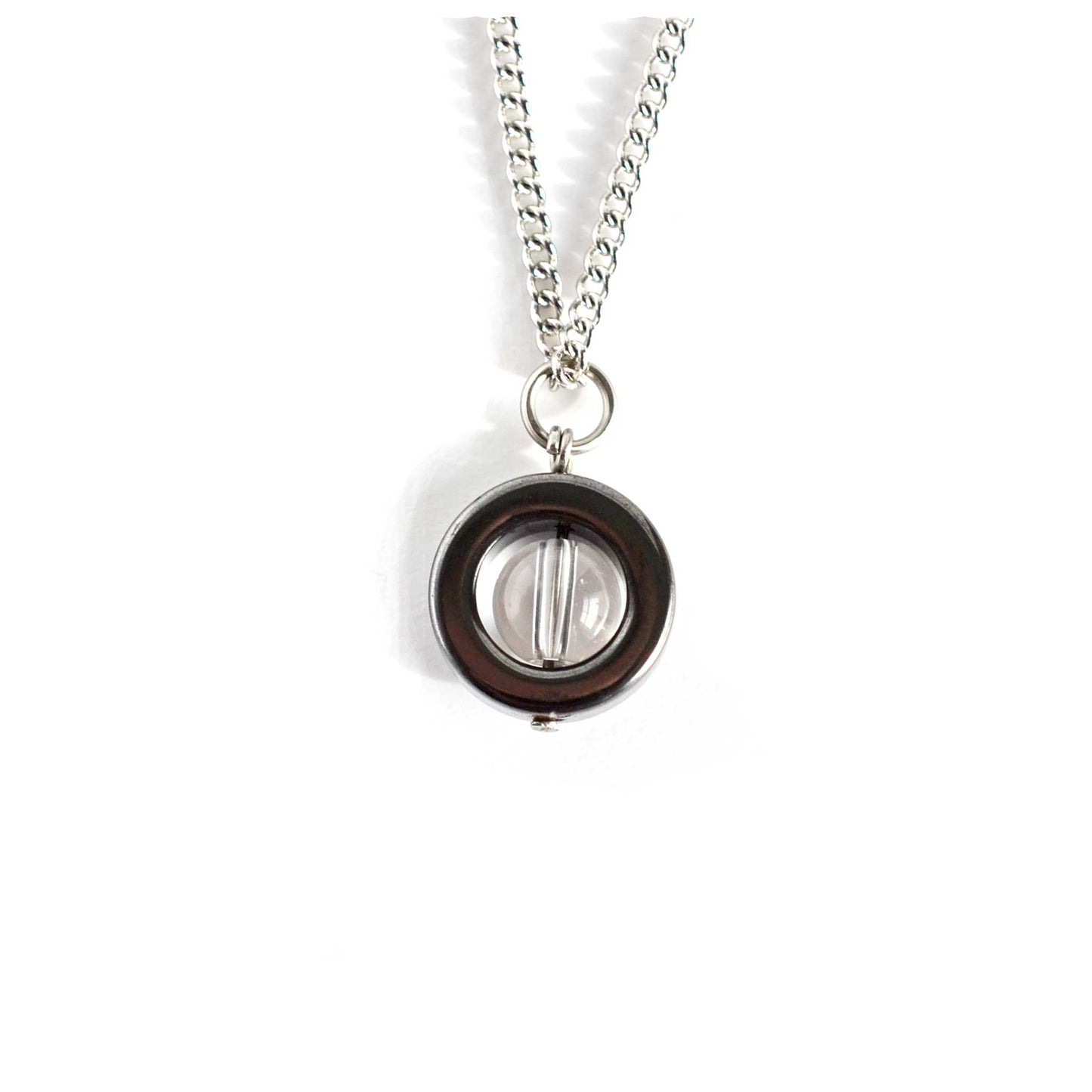 Hematite and clear Quartz Rock Crystal spinner necklace on white background.
