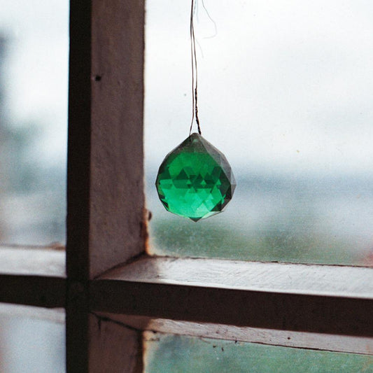 Green crystal hanging in window
