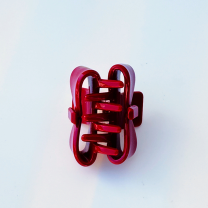 Red hair clip on a light blue background