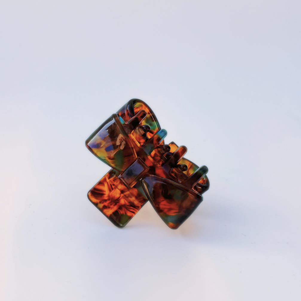 Tortoiseshell hair clip on a light gray background