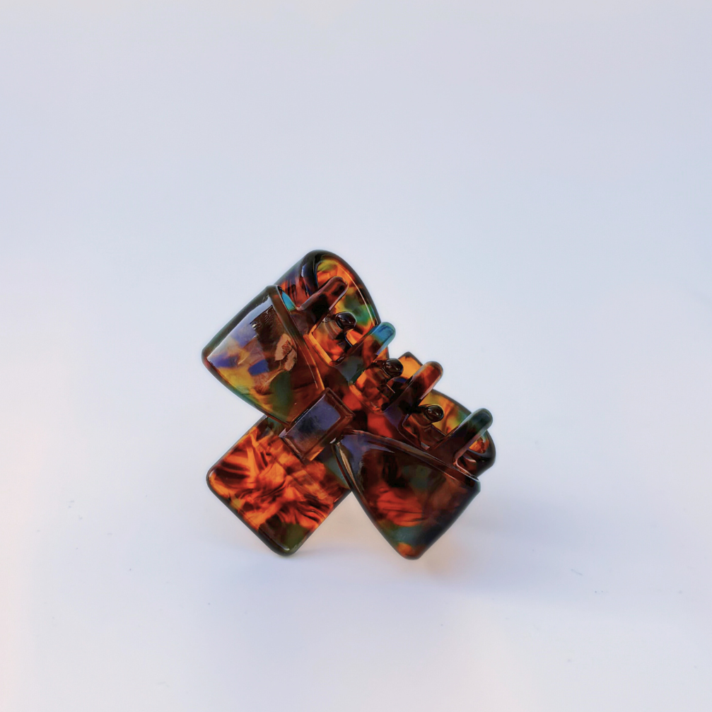 Tortoiseshell hair clip on a light gray background