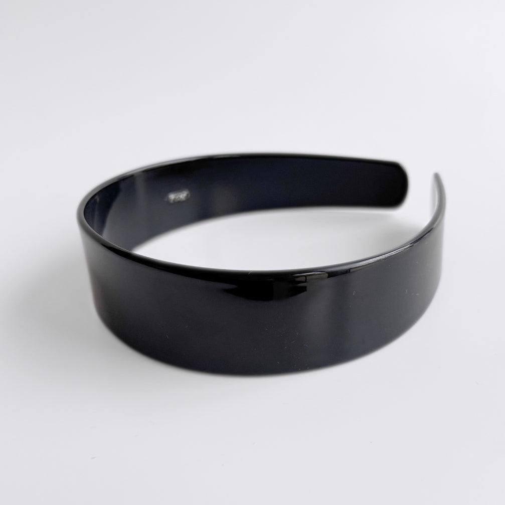 Black headband on a white background
