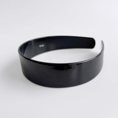 Black headband on a white background