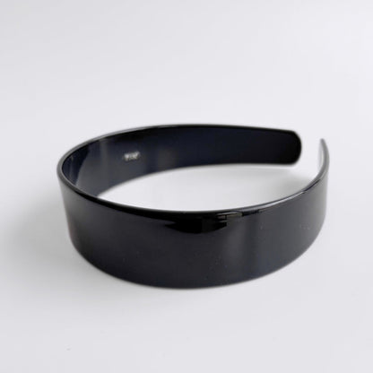 Black headband on a white background