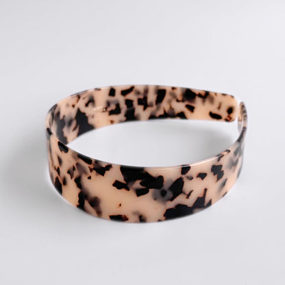 Leopard print headband on a light gray background