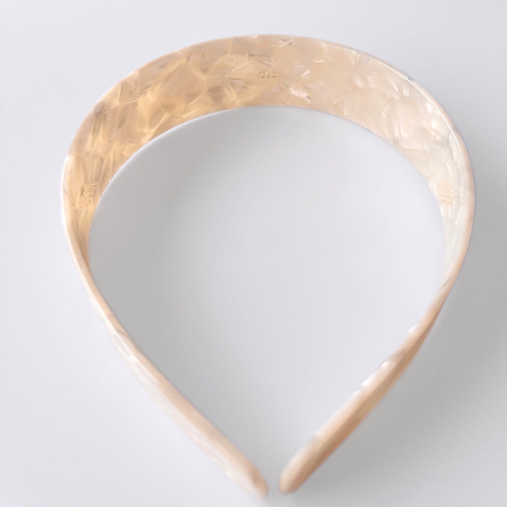 Cream headband on a light gray background