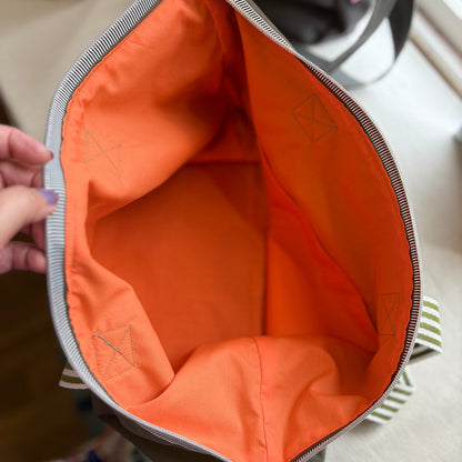 Orange interior of a bag with visible branding