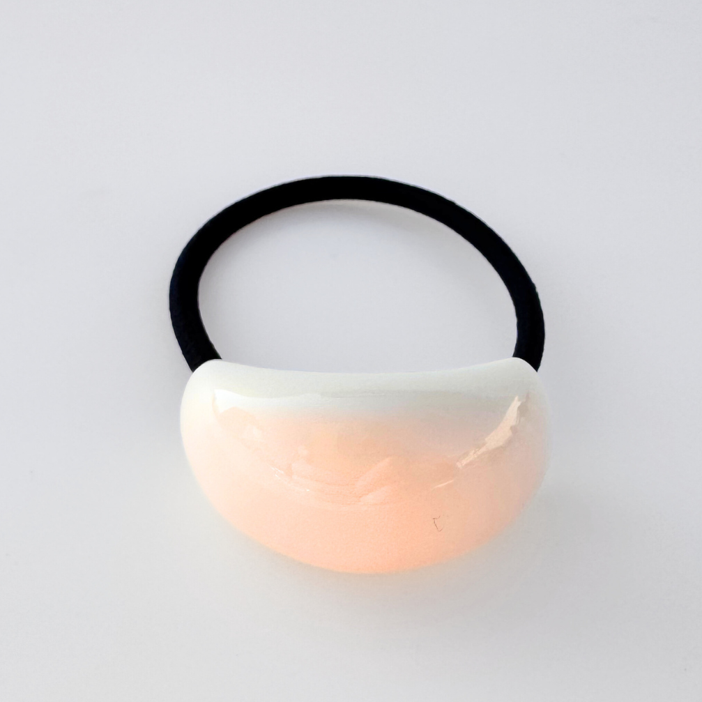 Hair tie with a gradient design on a light gray background