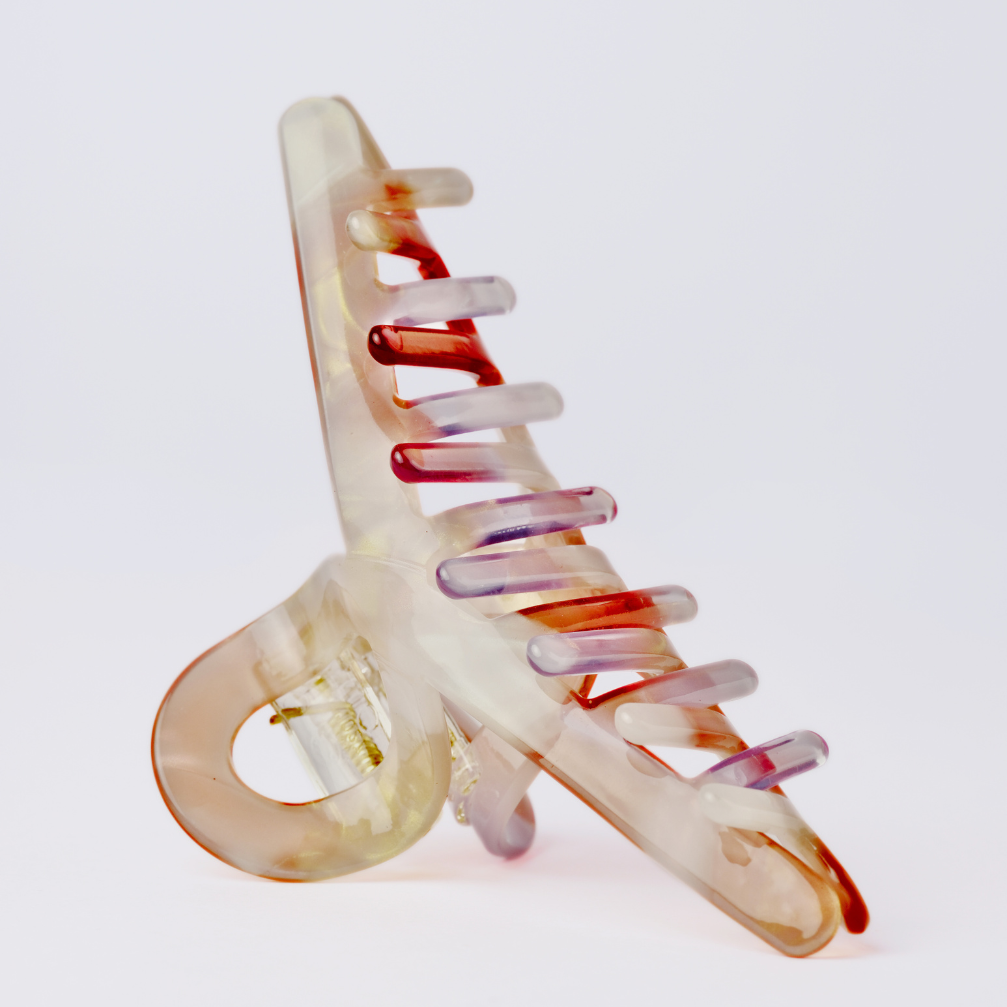 Multicolored hair clip on a light gray background