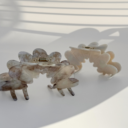 Set of two floral hair clips on a light background