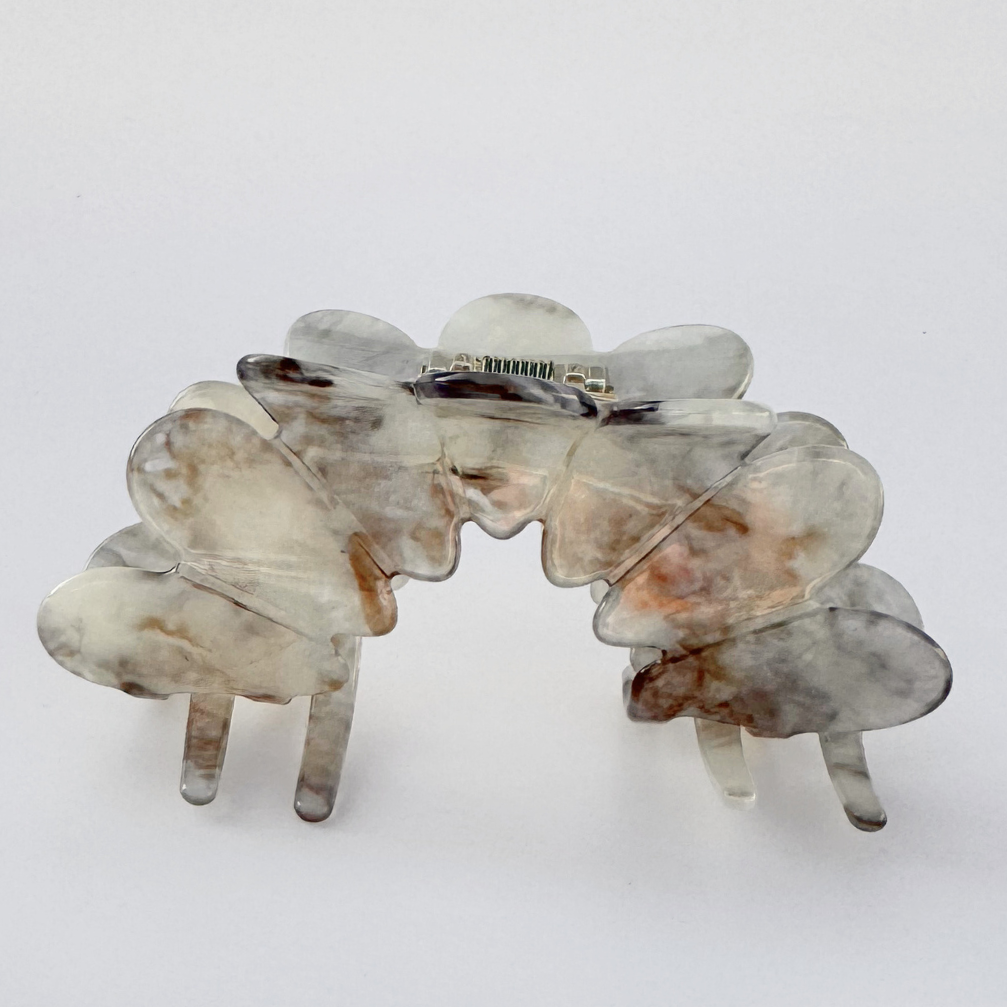 Marble-patterned hair clip on a white background