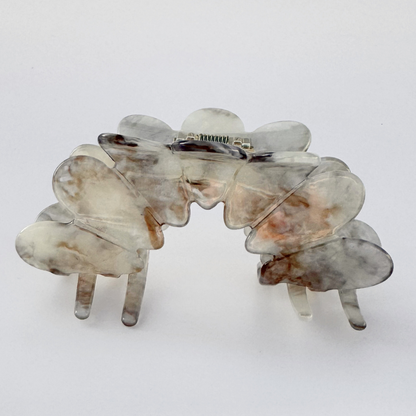 Marble-patterned hair clip on a white background