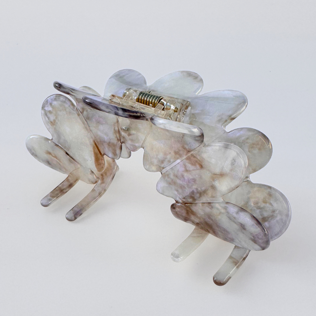 Clear hair clip on a light gray background