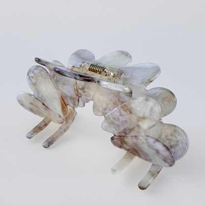 Clear hair clip on a light gray background