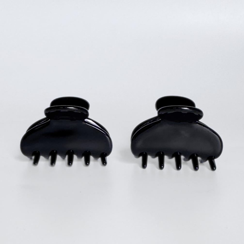 Two black hair clippers on a white background