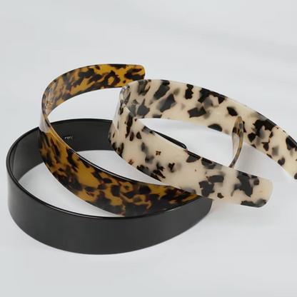 Three hairbands with leopard print, black, and beige patterns on a white background