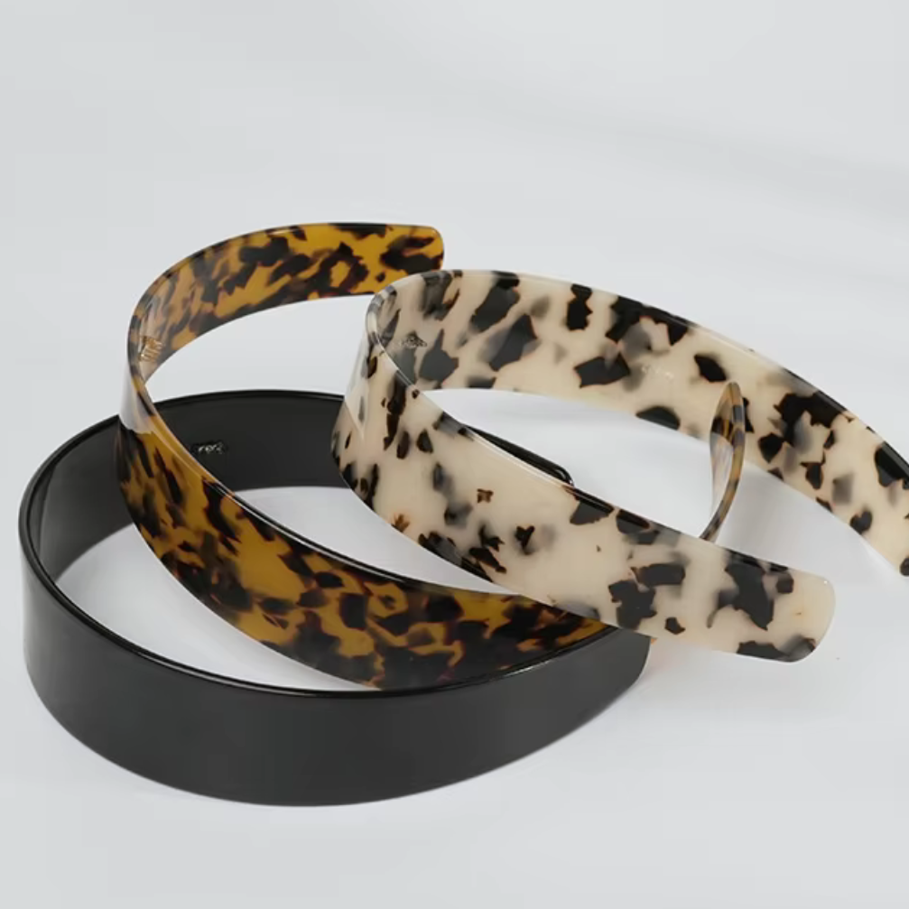 Three hairbands with leopard print, black, and beige patterns on a white background