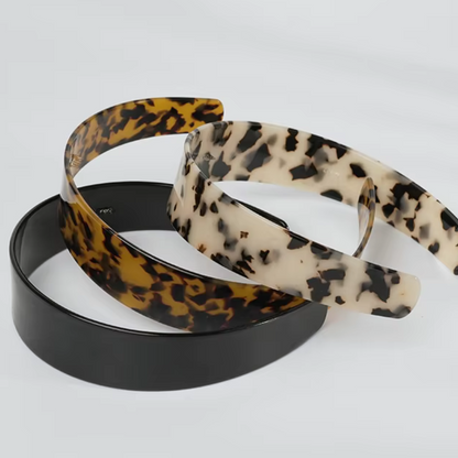 Three hairbands with leopard print, black, and beige patterns on a white background
