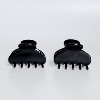 Two black hair clippers on a white background