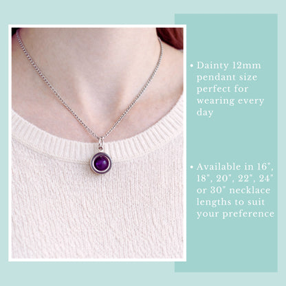 Model wearing pink jumper and purple Amethyst gemstone spinner necklace.
