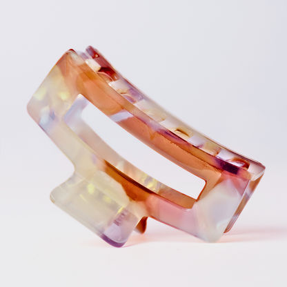 Multicolored hair clip on a light gray background