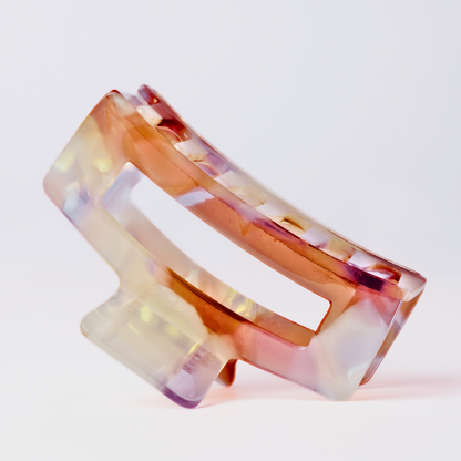 Multicolored hair clip on a light gray background