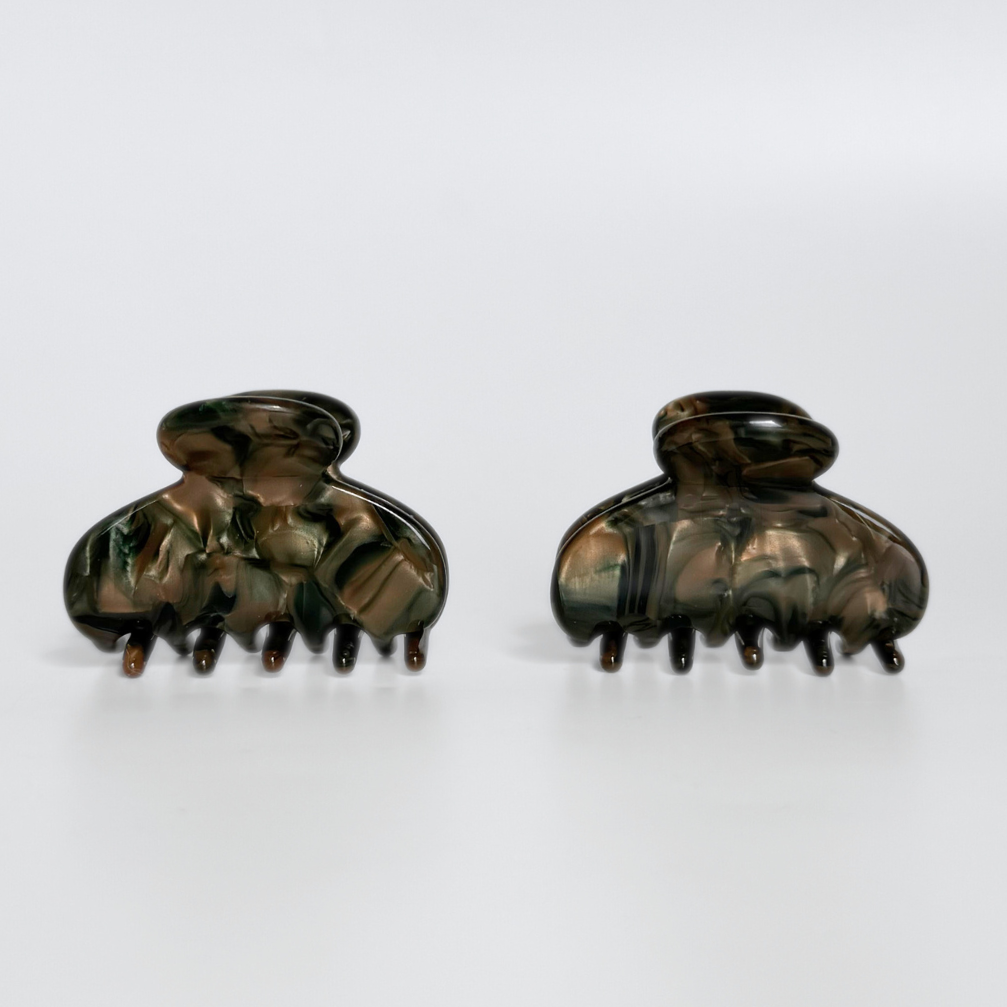 Pair of dark hair clamps on a white background