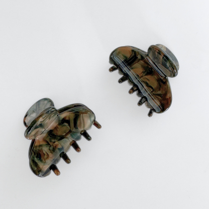 Pair of tortoiseshell hair clips on a white background