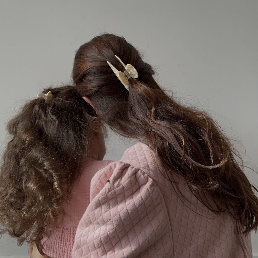 Mum and daughter wearing matching hair clips.