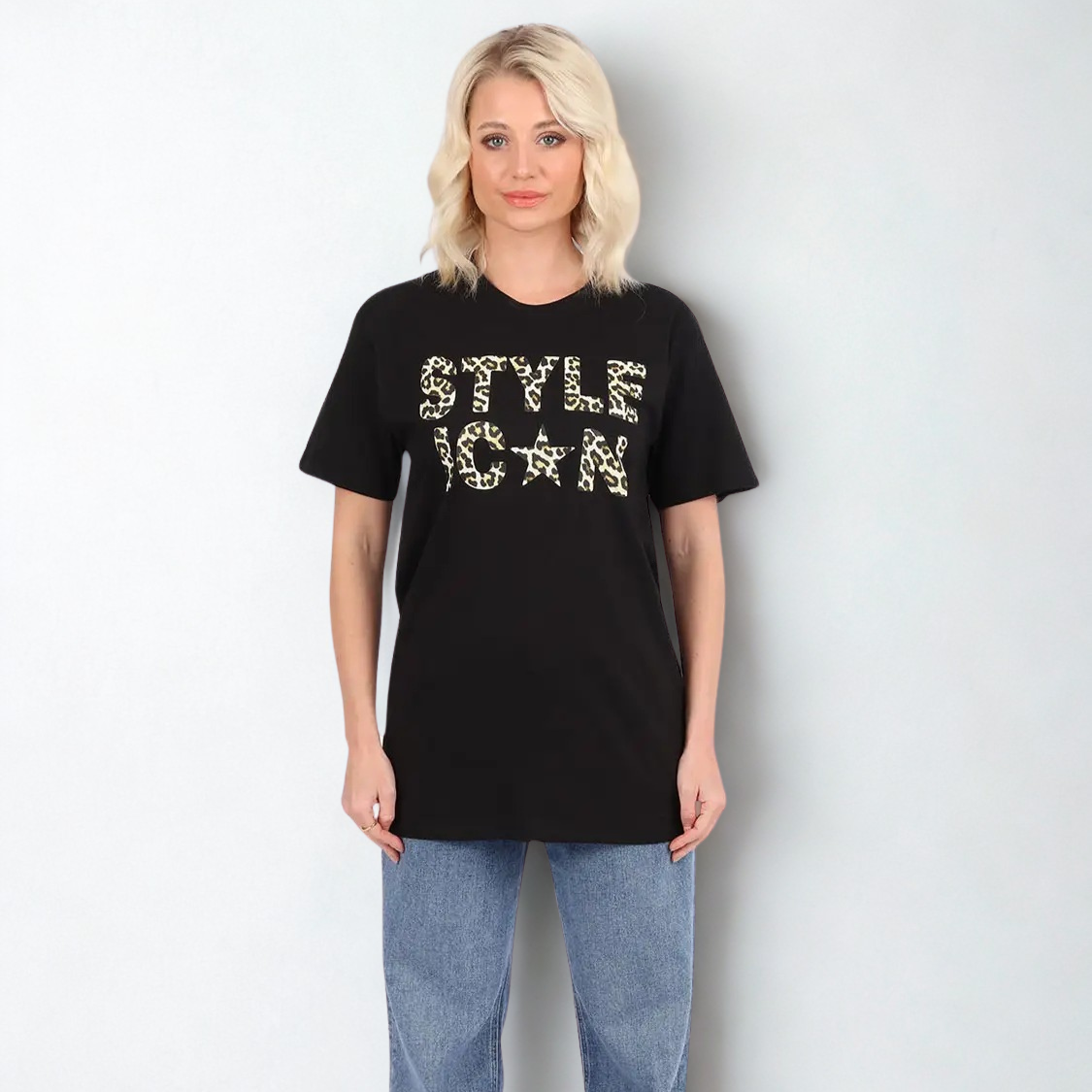 Person wearing a black t-shirt with 'STYLE ICON' text on a plain background