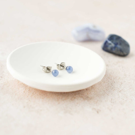 Tiny 4mm Blue gemstone stud earrings in trinket dish